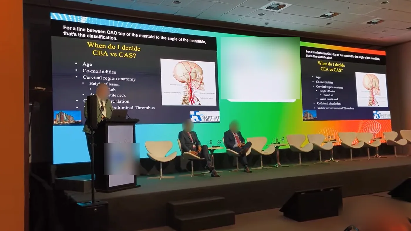 Palco do congresso com a legenda em inglês no alto do telão, sobre a apresentação